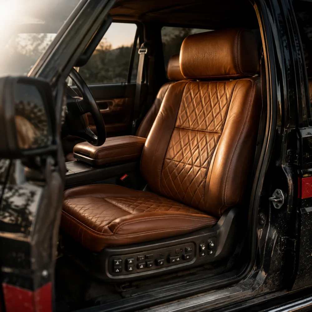 Tan leather ATHFINDER front seats with diamond stitching and the driver door open